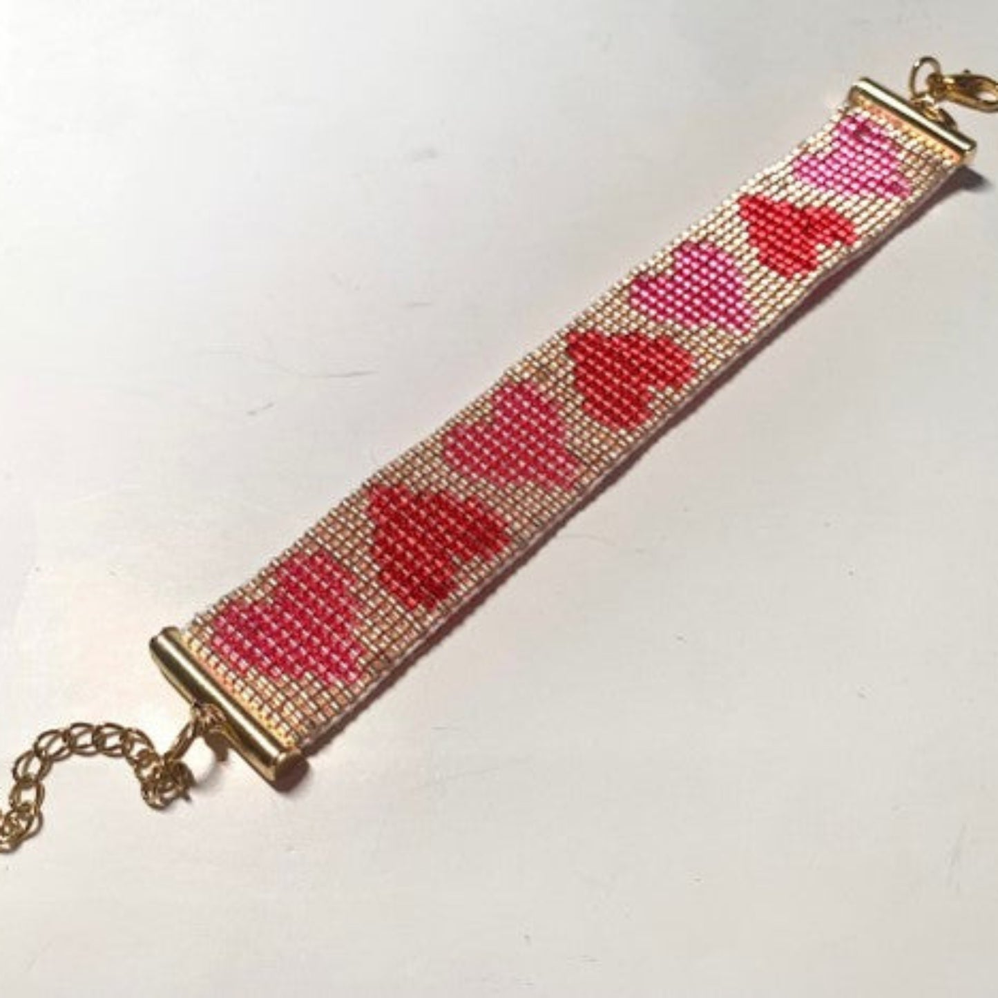 Beaded bracelet with heart pattern on a white background