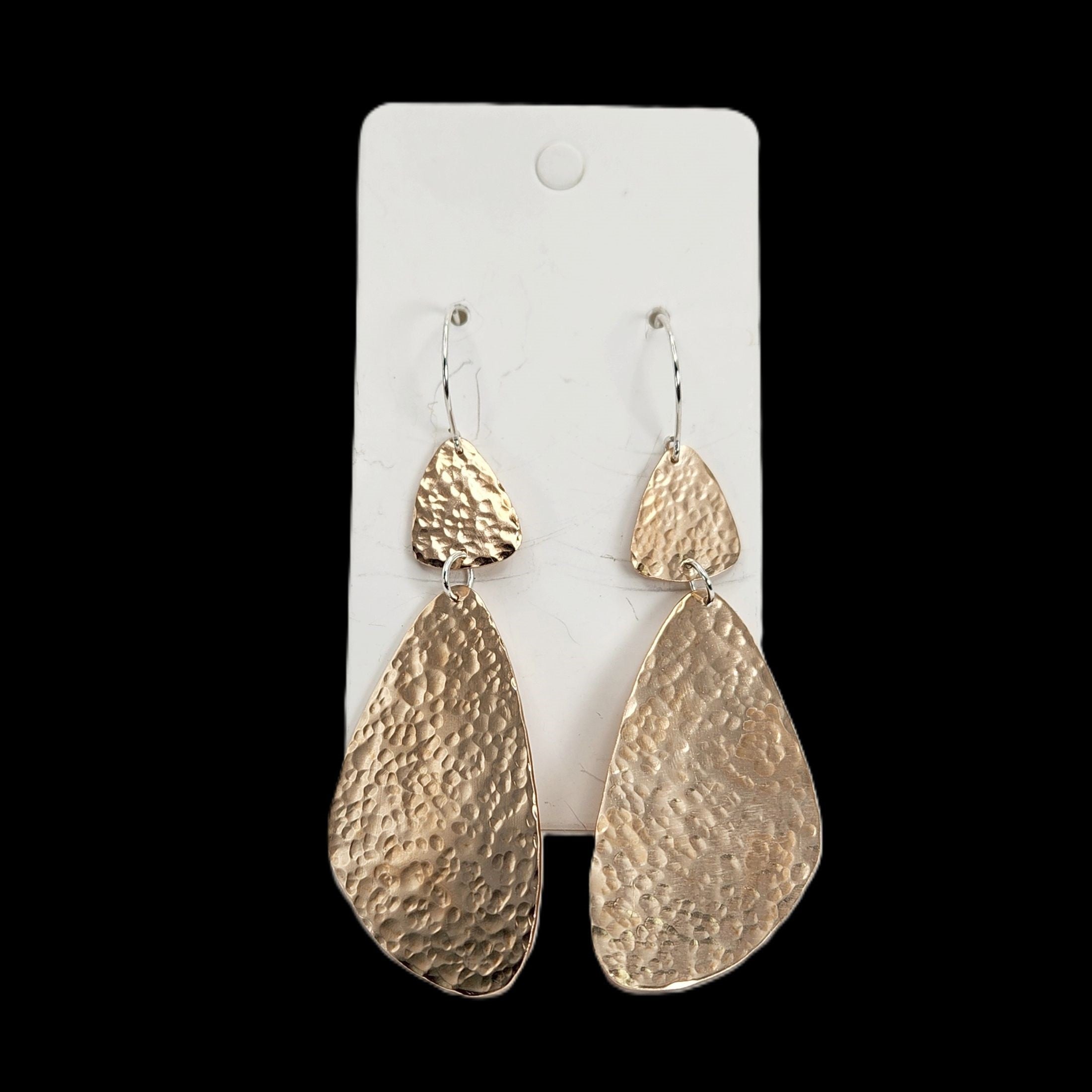 Bronze teardrop earrings on a white card with a black background